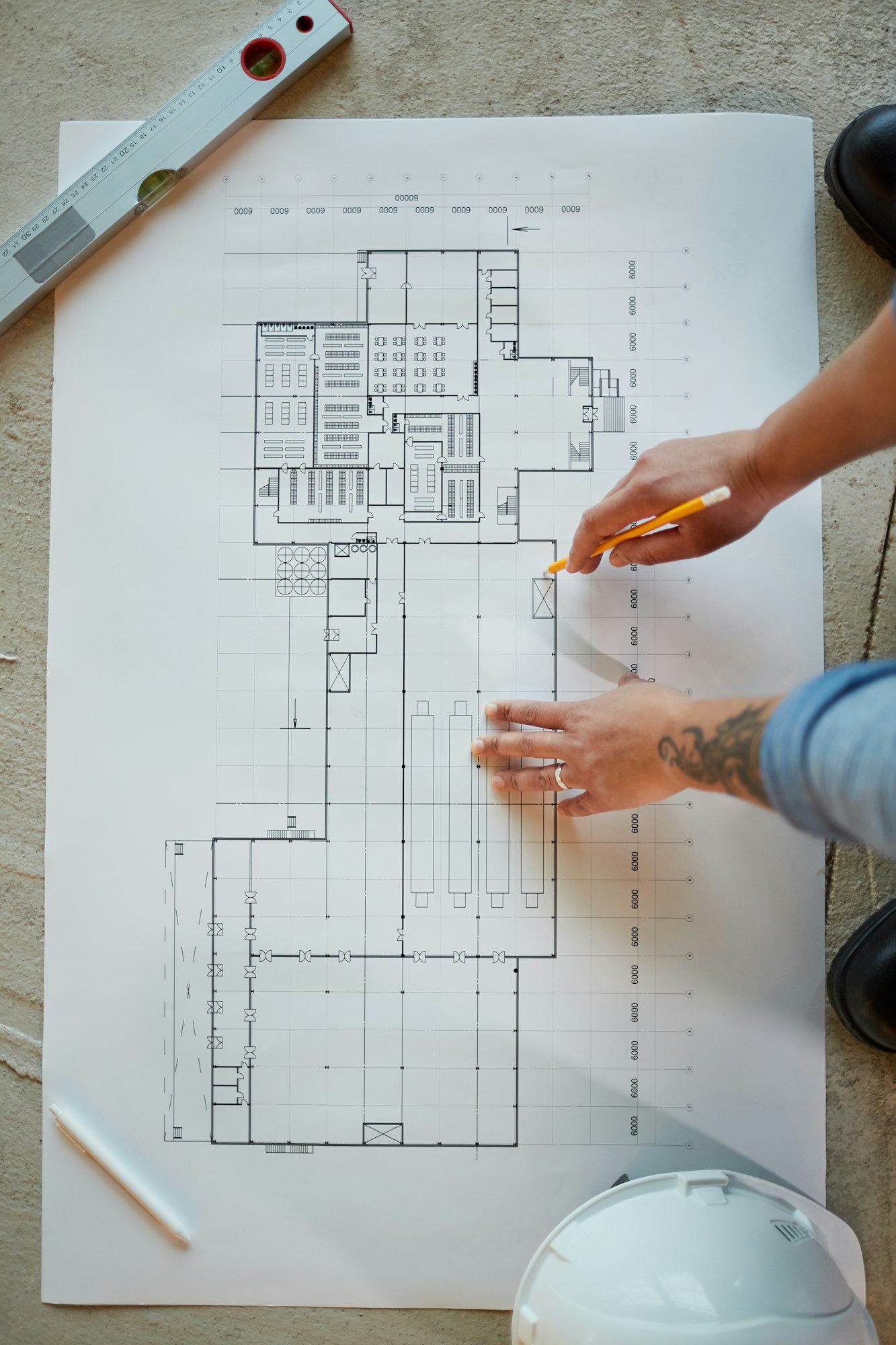 Female Worker Looking at Plans Top View